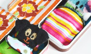 Free pattern for little wool dogs sewn from old sweaters. Perfect in little Altoids tin beds!