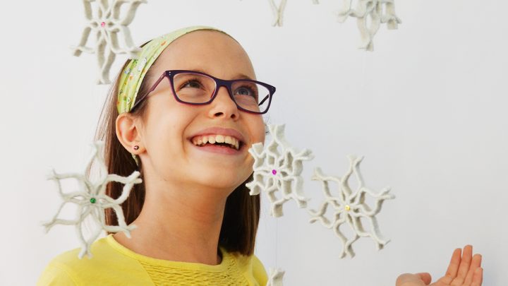 Create the magic of snowfall inside your home, but without the cold! Make these no sew felt snowflake ornaments from a surprising repurposed material: felted wool sweaters! Hang them on the Christmas tree or string them as a garland or from the ceiling for a magical decorative effect! #diysnowflake #feltsnowflake #snowflakechristmasornament