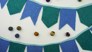 Make this wool felt banner DIY with craft felt or repurposed felted sweaters! A colorful and eco-friendly way to decorate your home or celebrate a party!